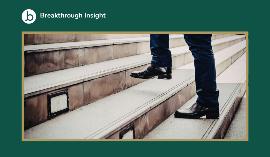 Career progression concept showing a person walking up steps, representing promotion and career development.